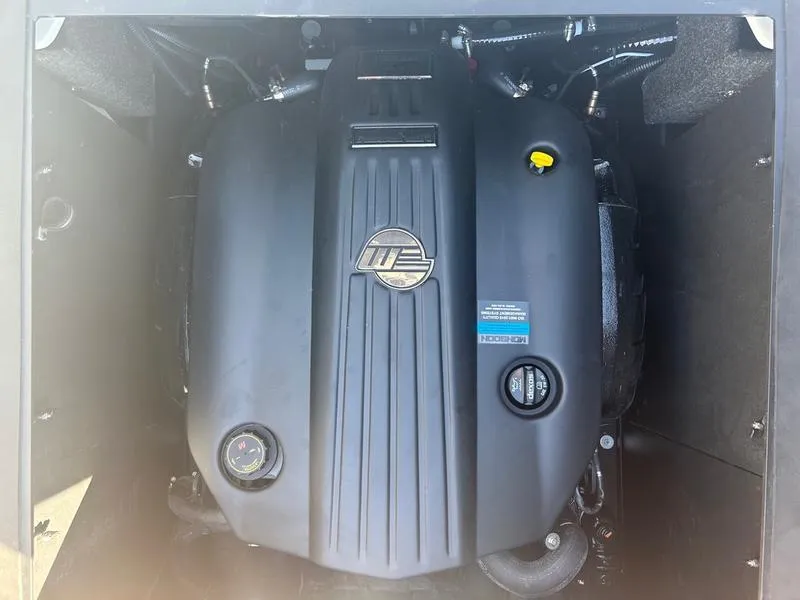 Slide: The Image of 2025 Axis T235 engine compartment with visible components and branding. - 2