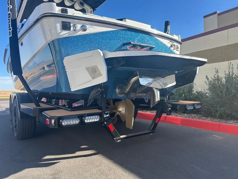 Slide: The Image of 2025 Axis T235 boat on trailer, showcasing rear view and propeller. - 5