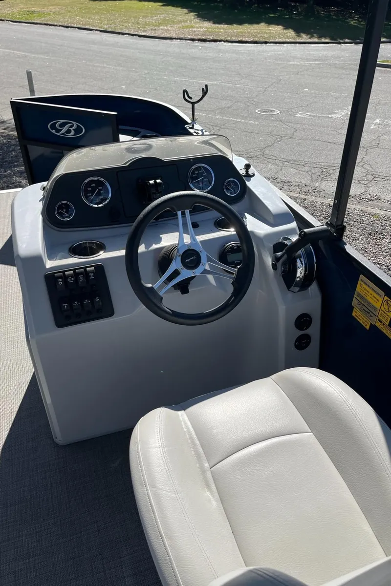 Slide: The Image of 2021 Bentley Pontoons 200 Fish dashboard with steering wheel and controls. - 15