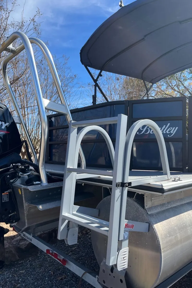 Slide: The Image of 2021 Bentley Pontoons 200 Fish with ladder and canopy, parked outdoors. - 4