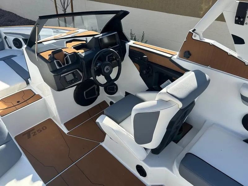 Slide: The Image of 2025 Axis T250 boat interior with modern dashboard and seating. - 12