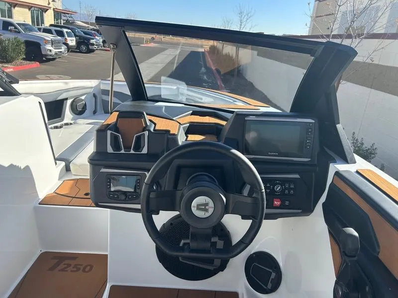 Slide: The Image of 2025 Axis T250 boat dashboard with steering wheel and navigation system. - 13