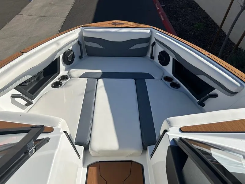 Slide: The Image of 2025 Axis T250 boat interior with cushioned seating and cup holders. - 14
