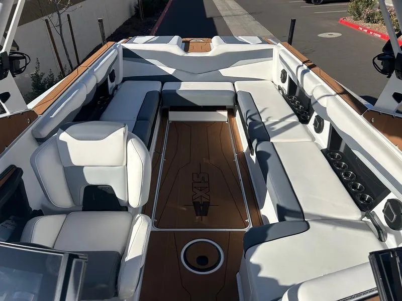 Slide: The Image of 2025 Axis T250 boat interior with white seating and wood accents. - 15