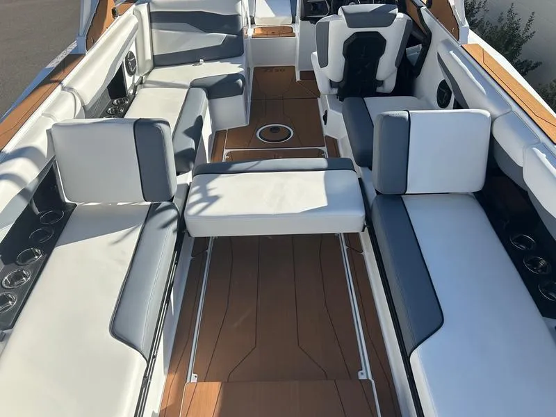 Slide: The Image of 2025 Axis T250 boat interior with white and gray seating, wooden flooring, and modern design. - 16