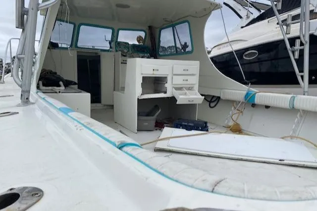 Slide: The Image of 1988 Robertson Sportfish boat interior with storage drawers and seating area. - 7