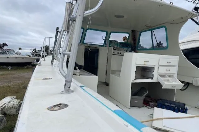 Slide: The Image of 1988 Robertson Sportfish boat with open deck and storage compartments. - 8