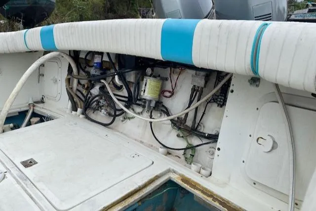 Slide: The Image of 1988 Robertson Sportfish boat interior with visible wiring and storage compartments. - 9