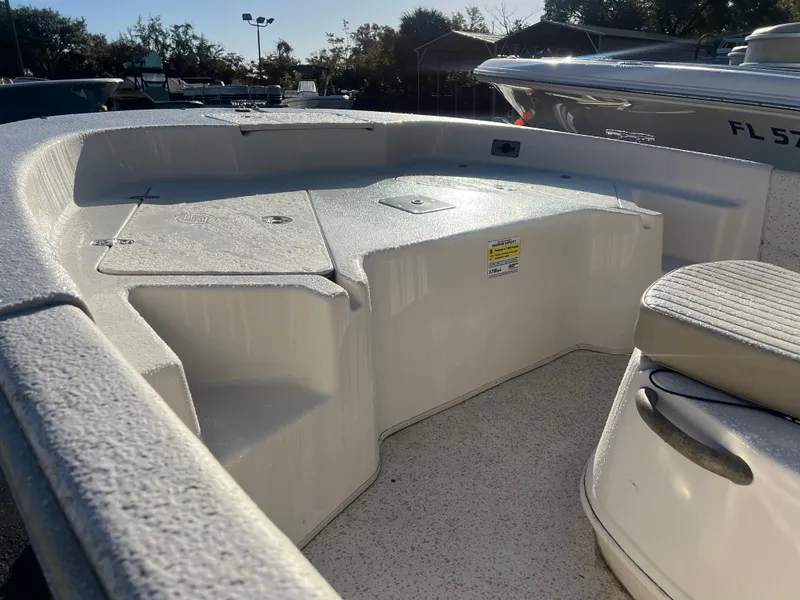 Slide: The Image of 2018 Carolina Skiff 178 DLV Series boat interior with seating and storage compartments. - 3