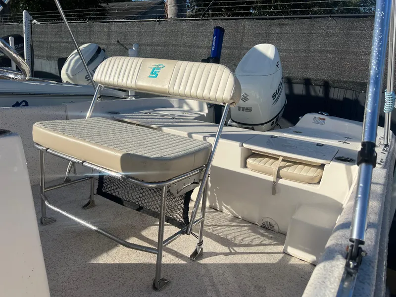 Slide: The Image of 2018 Carolina Skiff 178 DLV Series boat interior with seating and Suzuki outboard motor. - 4