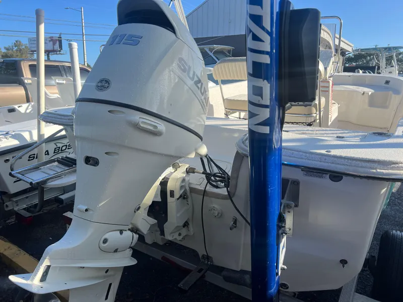 Slide: The Image of 2018 Carolina Skiff 178 DLV Series with Suzuki outboard motor, docked outdoors. - 6