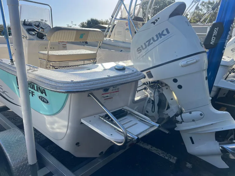 Slide: The Image of 2018 Carolina Skiff 178 DLV Series boat with Suzuki outboard motor on trailer. - 7