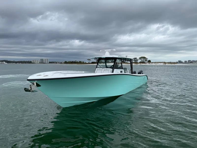 Slide: The Image of 2023 Yellowfin 42 Offshore boat on calm water under cloudy skies. - 12