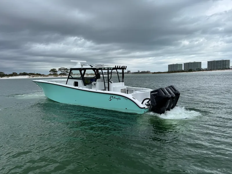 Slide: The Image of 2023 Yellowfin 42 Offshore boat cruising on a cloudy day near the shoreline. - 14