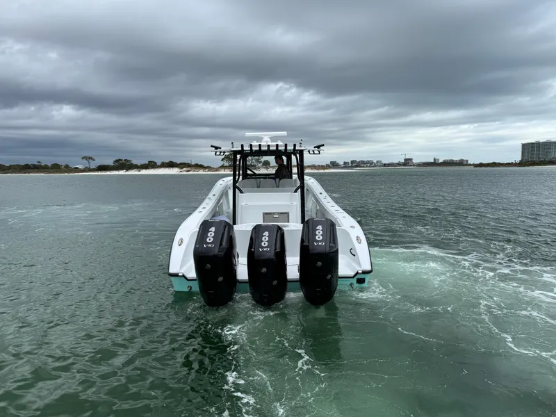 Slide: The Image of 2023 Yellowfin 42 Offshore boat with triple engines on open water. - 17