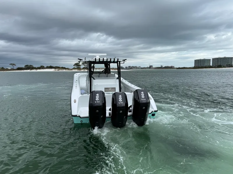 Slide: The Image of 2023 Yellowfin 42 Offshore boat with triple outboard engines on water. - 18