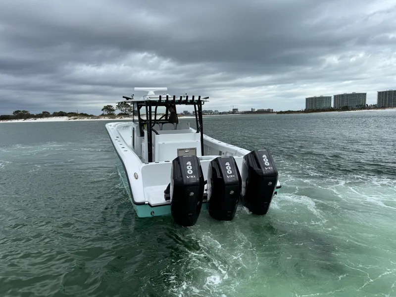 Slide: The Image of 2023 Yellowfin 42 Offshore boat with triple engines on a cloudy day. - 19