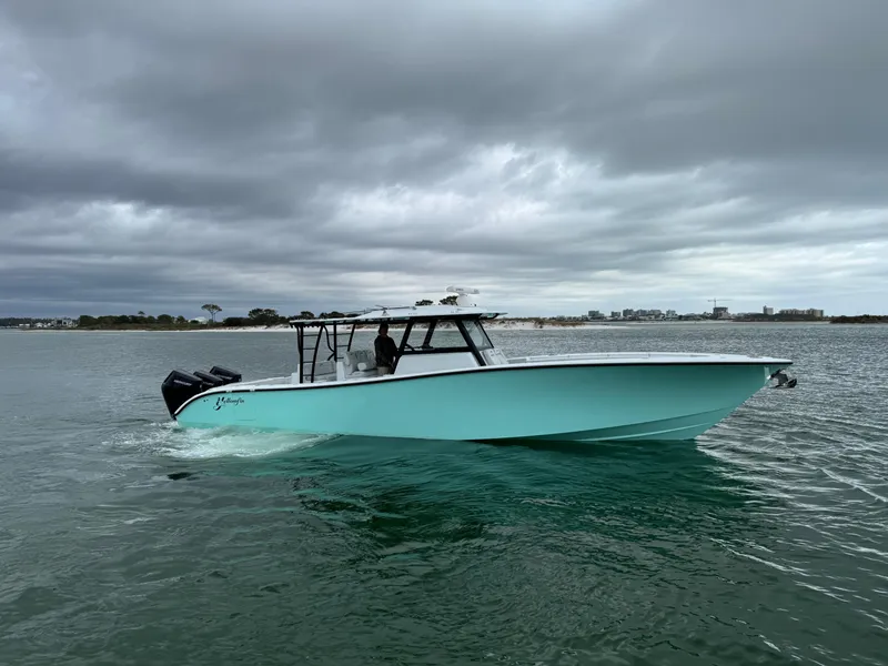 Slide: The Image of 2023 Yellowfin 42 Offshore boat on calm water under cloudy skies. - 2