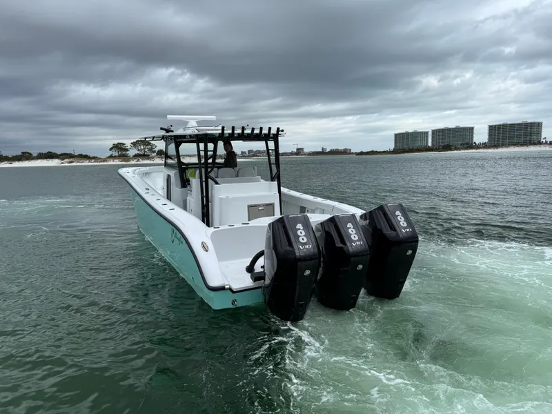Slide: The Image of 2023 Yellowfin 42 Offshore boat with triple engines on open water. - 20