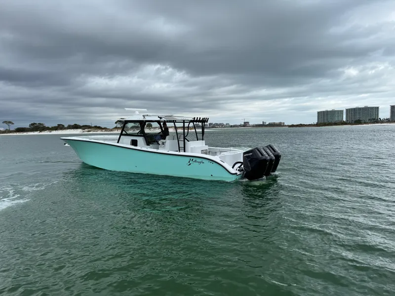 Slide: The Image of 2023 Yellowfin 42 Offshore boat on water under cloudy sky. - 23