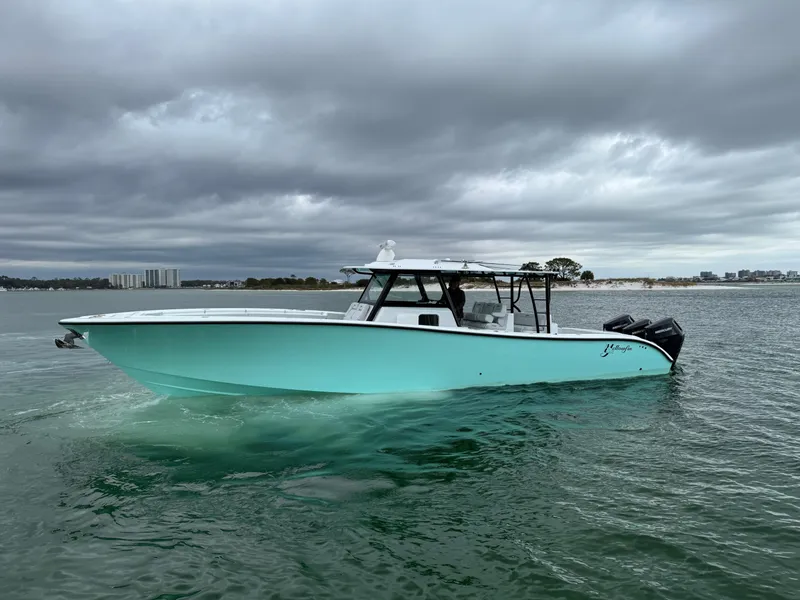 Slide: The Image of 2023 Yellowfin 42 Offshore boat on water under cloudy skies. - 25