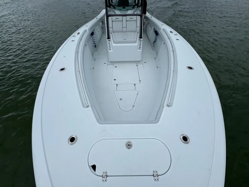 Slide: The Image of 2023 Yellowfin 42 Offshore boat, spacious deck, sleek design, on calm water. - 26