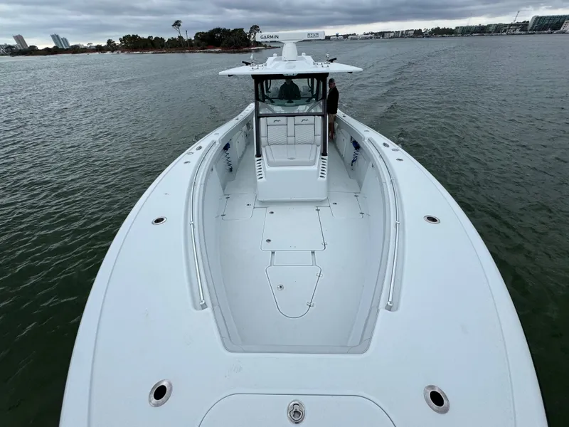 Slide: The Image of 2023 Yellowfin 42 Offshore boat on calm water, showcasing spacious deck design. - 27