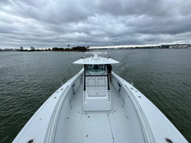 Slide: The Image of 2023 Yellowfin 42 Offshore boat on open water under cloudy skies. - 28