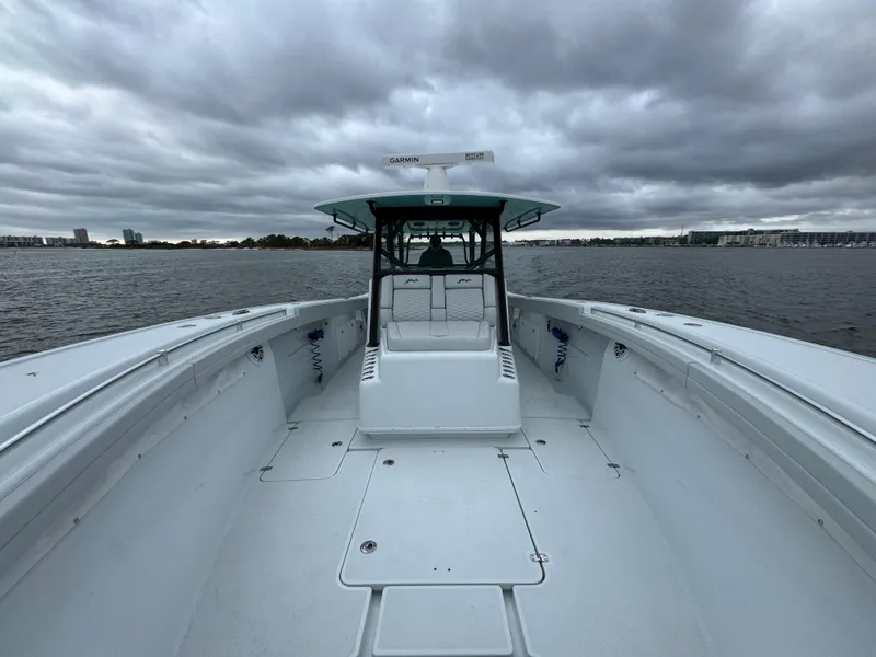 Slide: The Image of 2023 Yellowfin 42 Offshore boat on water under cloudy sky. - 29