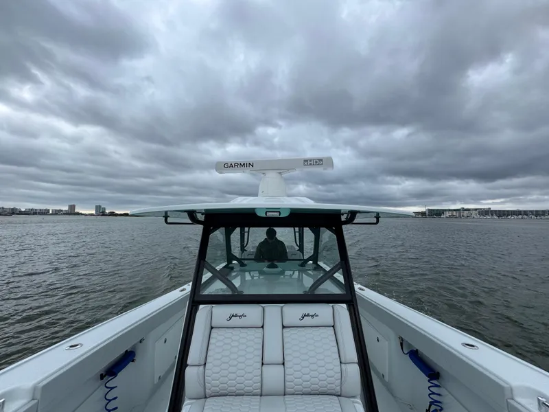 Slide: The Image of 2023 Yellowfin 42 Offshore boat on water under cloudy sky. - 31