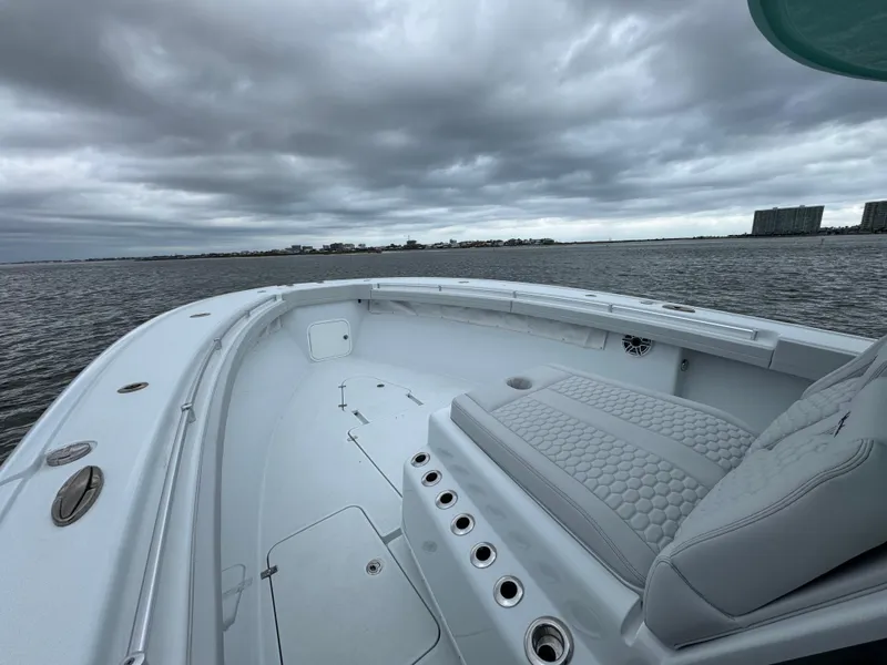 Slide: The Image of 2023 Yellowfin 42 Offshore boat on water under cloudy sky. - 32
