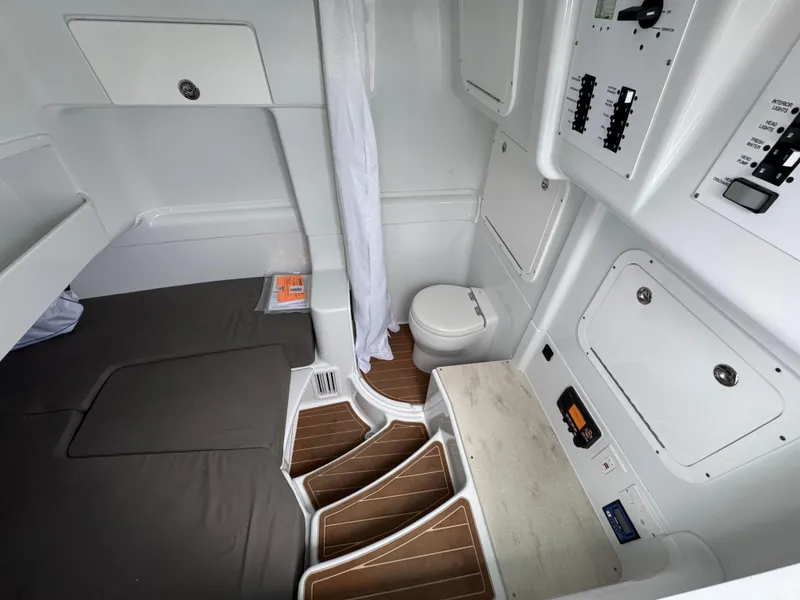 Slide: The Image of 2023 Yellowfin 42 Offshore cabin interior with bed, toilet, and control panels. - 35