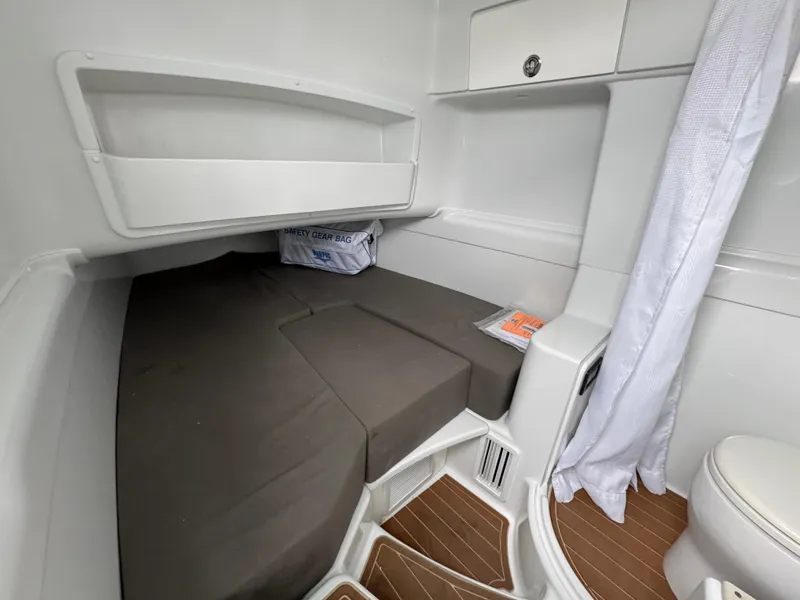 Slide: The Image of 2023 Yellowfin 42 Offshore cabin interior with bed, storage, and wooden flooring. - 36