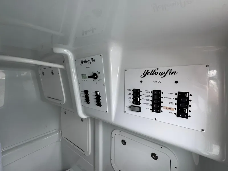 Slide: The Image of Control panel of 2023 Yellowfin 42 Offshore boat, featuring electrical switches and labels. - 38