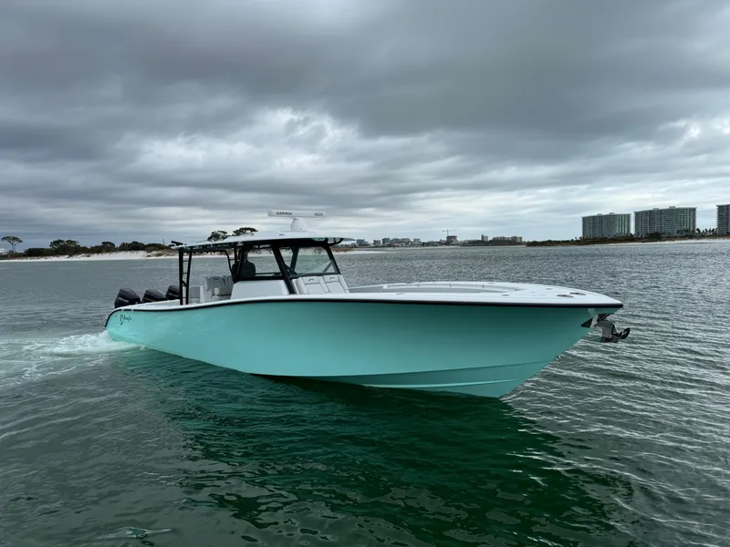 Slide: The Image of 2023 Yellowfin 42 Offshore boat cruising on a cloudy day near the shoreline. - 4