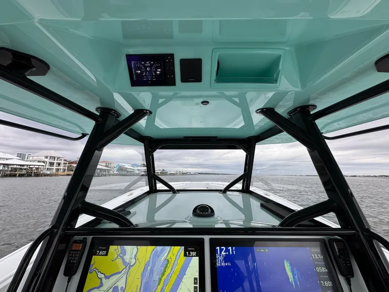 Slide: The Image of 2023 Yellowfin 42 Offshore boat cockpit with navigation screens and ocean view. - 40