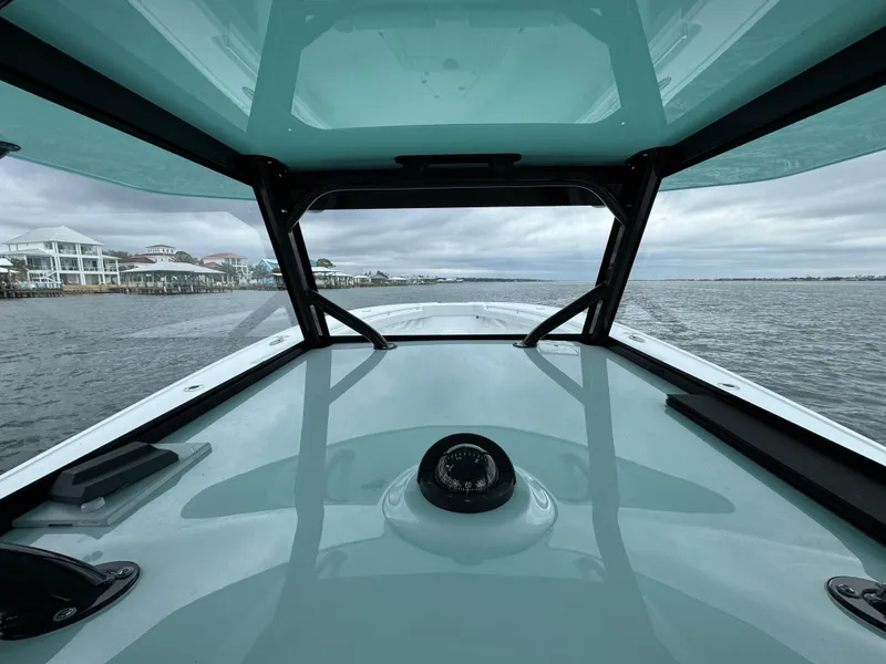 Slide: The Image of 2023 Yellowfin 42 Offshore boat interior view, navigating calm waters. - 41
