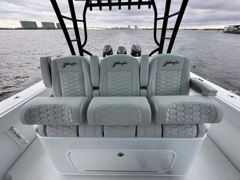Slide: The Image of 2023 Yellowfin 42 Offshore boat seats with hexagonal pattern, overlooking water. - 44