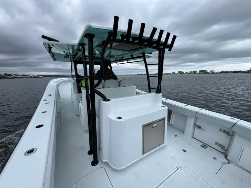 Slide: The Image of 2023 Yellowfin 42 Offshore boat on water under cloudy skies. - 49