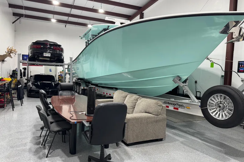 Slide: The Image of 2023 Yellowfin 42 Offshore boat in a garage with cars and office furniture. - 57