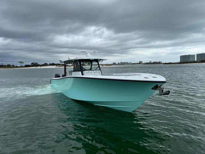Slide: The Image of 2023 Yellowfin 42 Offshore boat cruising on a cloudy day near the shoreline. - 6