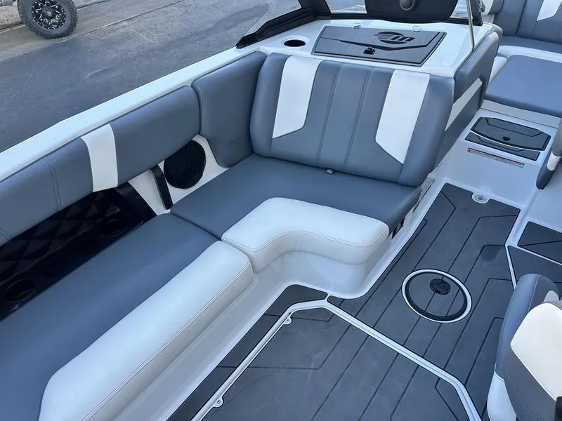 Slide: The Image of 2024 Malibu 21 LX-R boat interior with gray and white seating and modern design. - 11