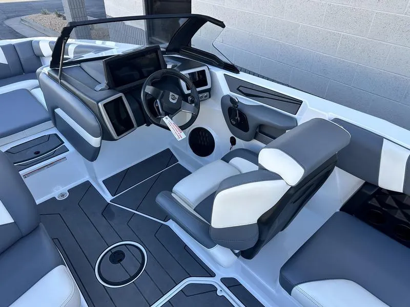 Slide: The Image of 2024 Malibu 21 LX-R boat interior with modern dashboard and seating. - 12