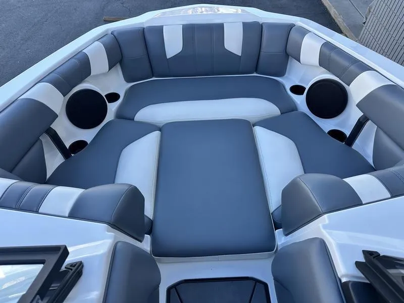 Slide: The Image of 2024 Malibu 21 LX-R boat interior with gray and white cushioned seating. - 13
