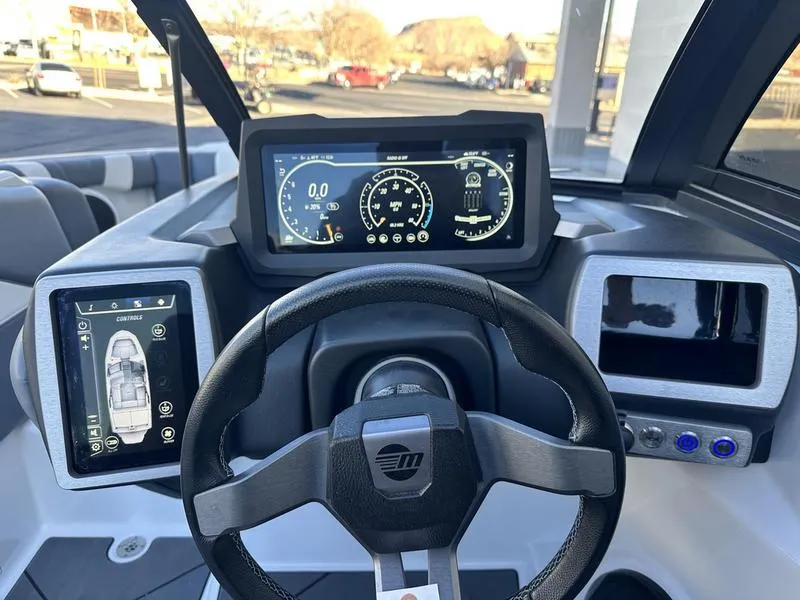 Slide: The Image of 2024 Malibu 21 LX-R boat dashboard with digital displays and steering wheel. - 3