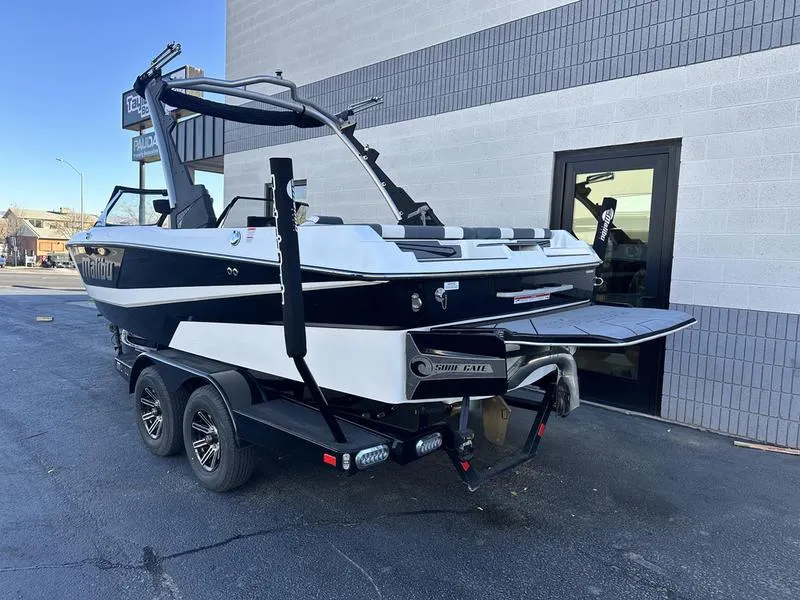 Slide: The Image of 2024 Malibu 21 LX-R boat on trailer, parked outside a building. - 4