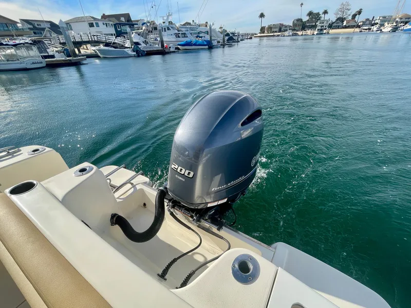Slide: The Image of 2020 Scout 215 XSF boat with Yamaha 200 outboard motor in a marina. - 10