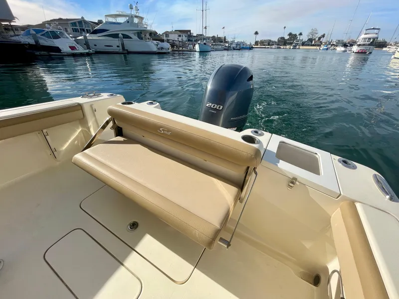 Slide: The Image of 2020 Scout 215 XSF boat interior with seating and outboard motor in marina. - 13