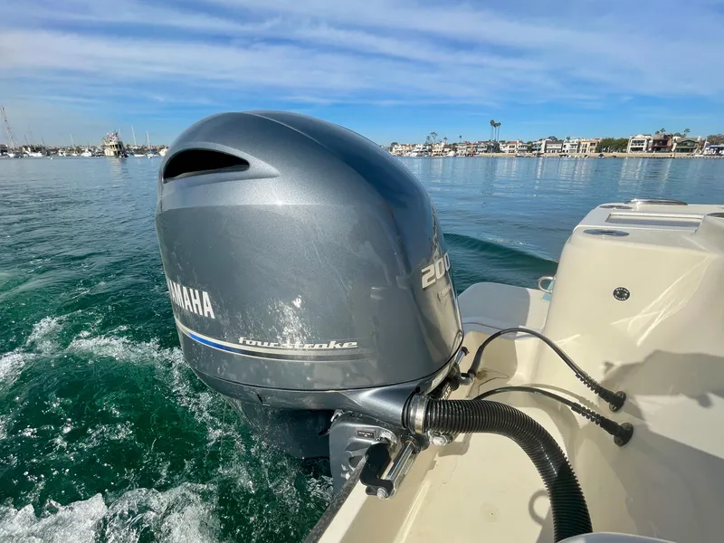 Slide: The Image of 2020 Scout 215 XSF boat with Yamaha outboard motor on calm water. - 16