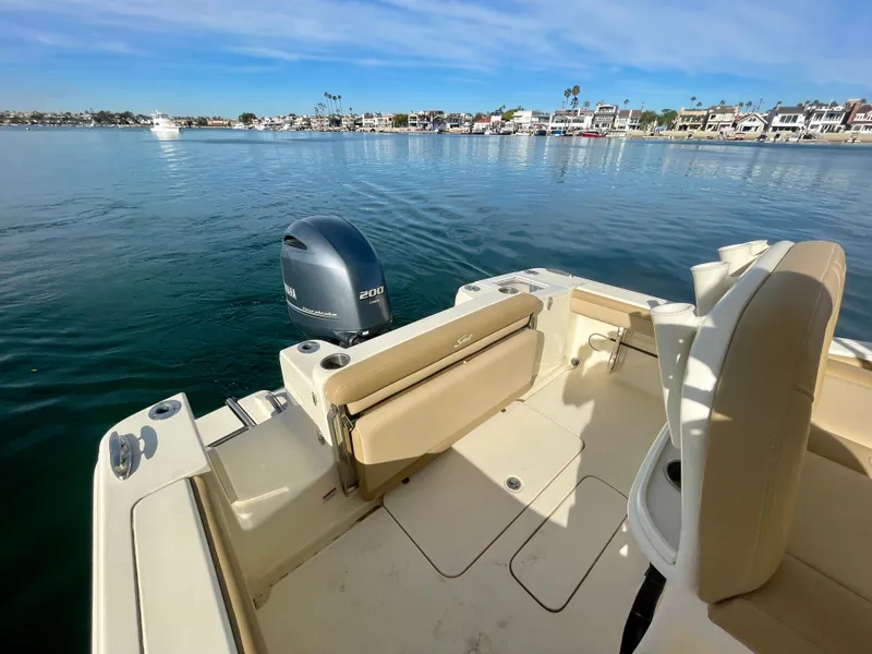 Slide: The Image of 2020 Scout 215 XSF boat interior with Yamaha outboard motor on calm water. - 20